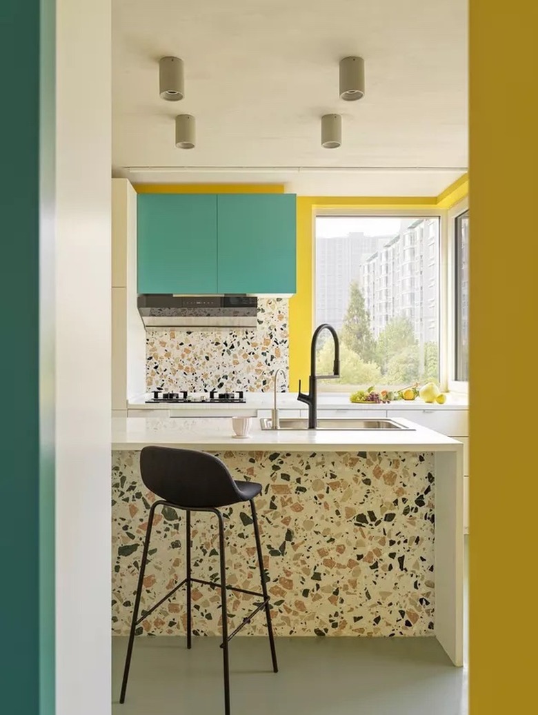 bright contemporary kitchen with terrazzo and yellow walls