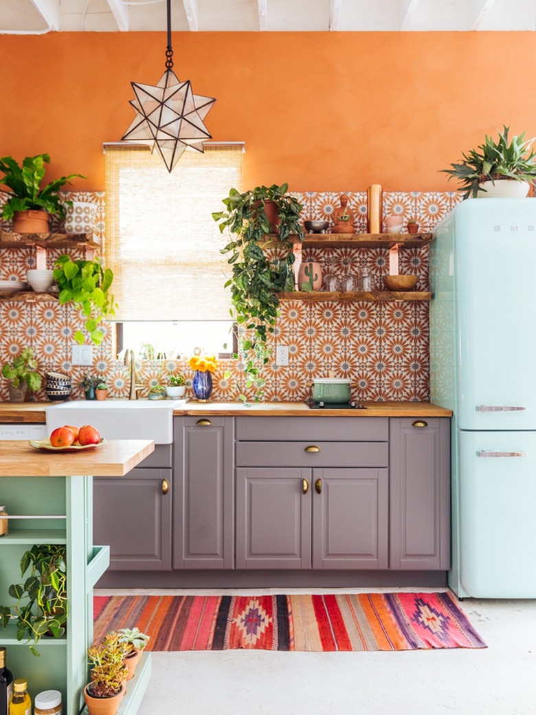 orange kitchen with retro fridge and boho decor