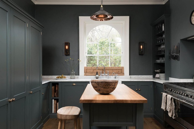 dark gray kitchen with white countertops and wood floor