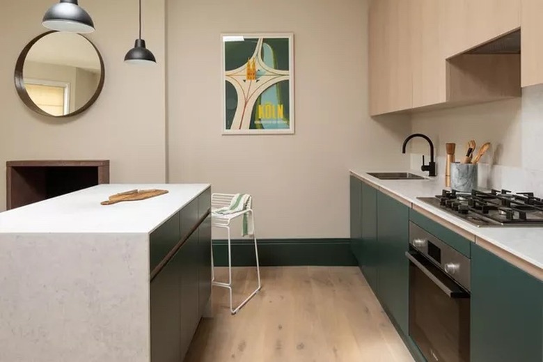 modern kitchen with cream walls and green cabinets