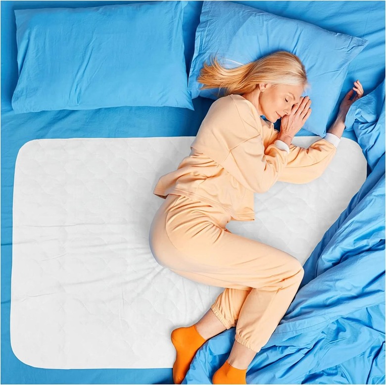 woman sleeping on mattress pad