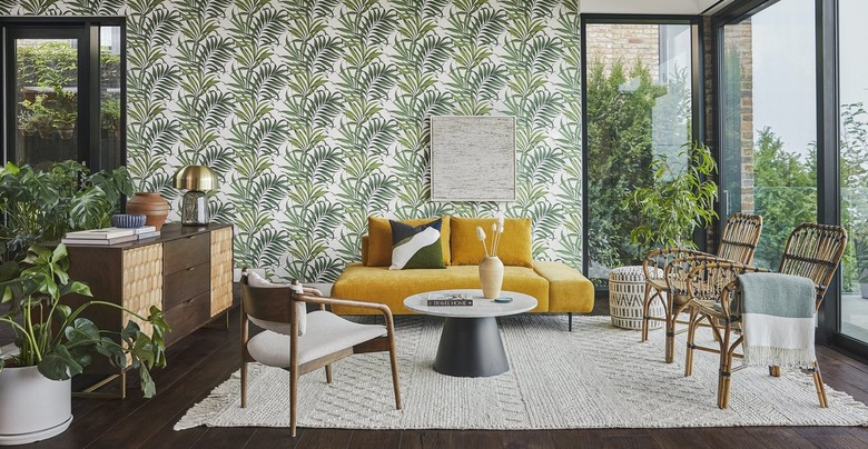 Yellow couch in wallpapered living room