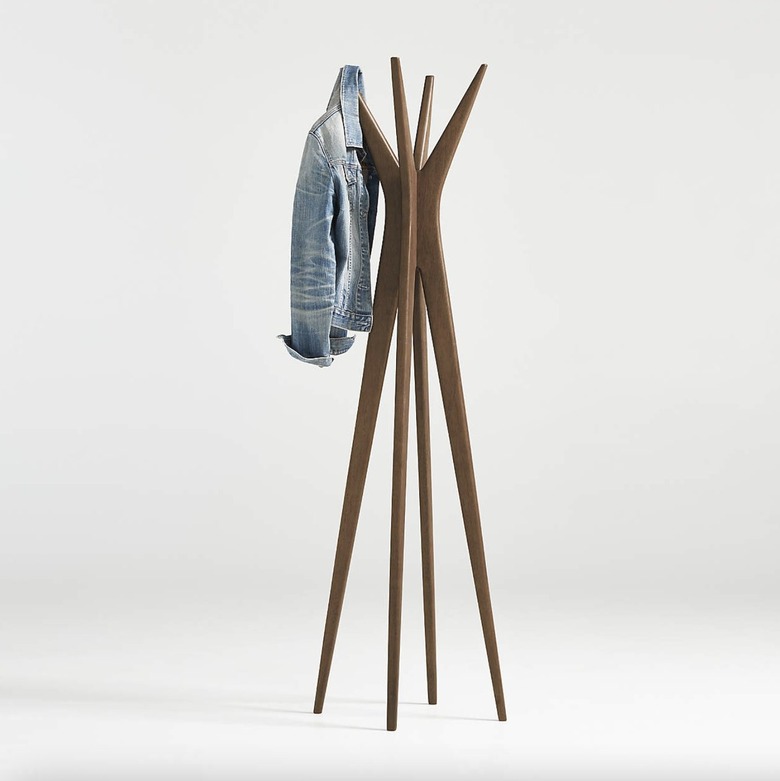 wooden midcentury modern coat rack with jean jacket hanging