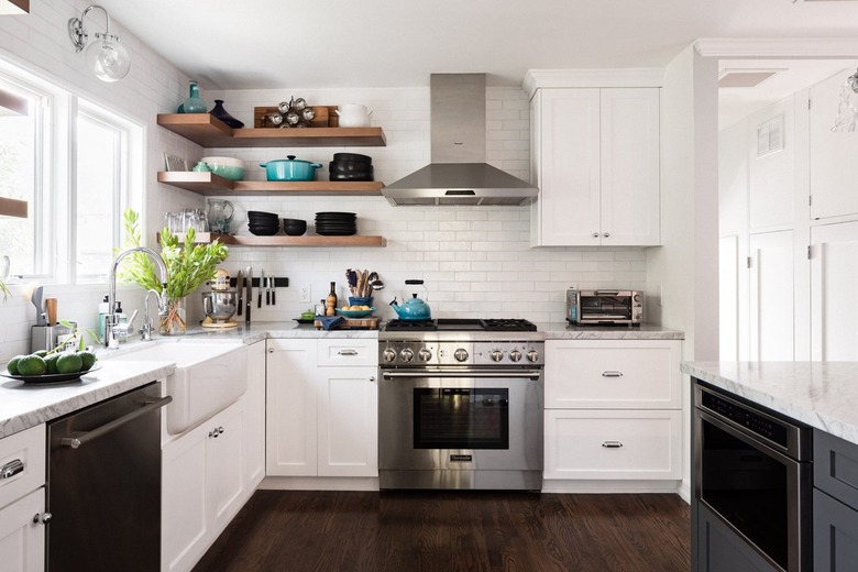 Simple white kitchen with gray island cabinets and calacatta marble.