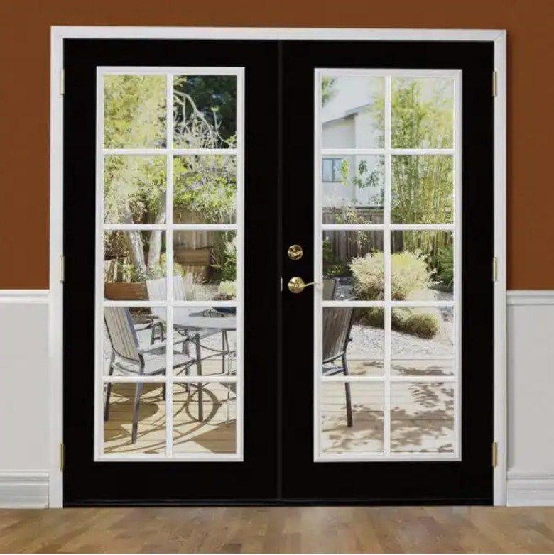 Glass patio doors with black trim from the inside looking out to the back patio.