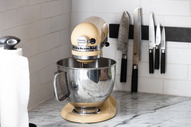 yellow kitchenaid on marble countertop