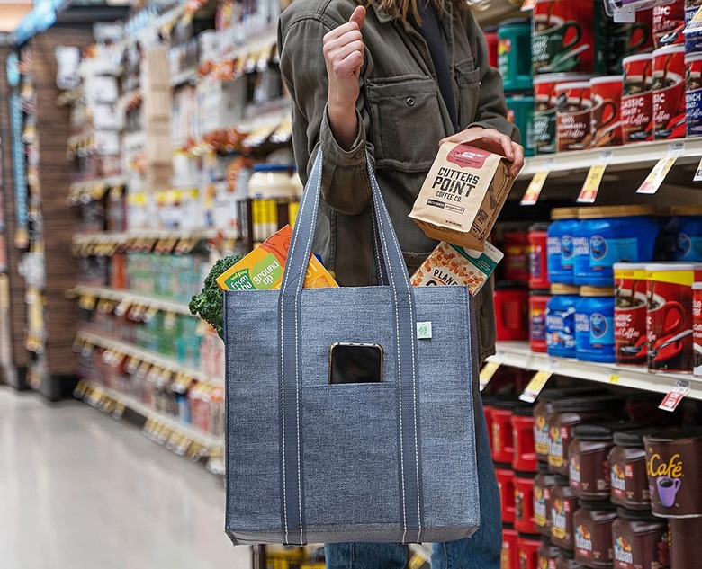 person grocery shopping with reusable bag