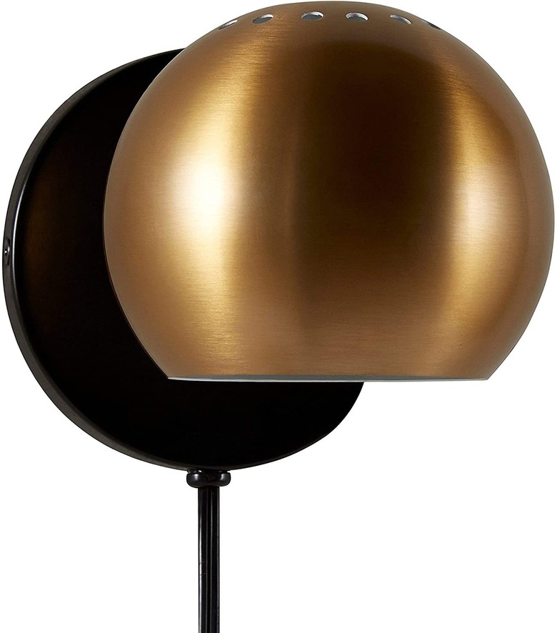 round gold metal plug in wall sconce with black base