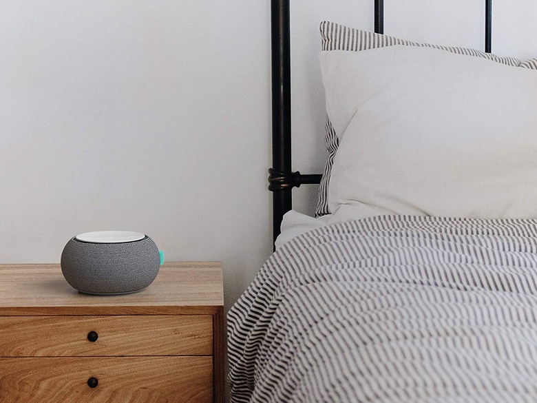 White noise machine next to made bed