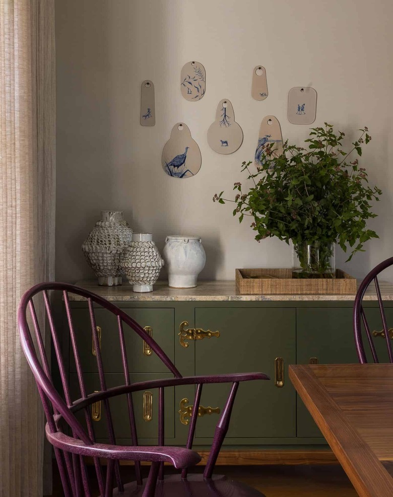 Taupe color in dining room with purple chairs and green buffet