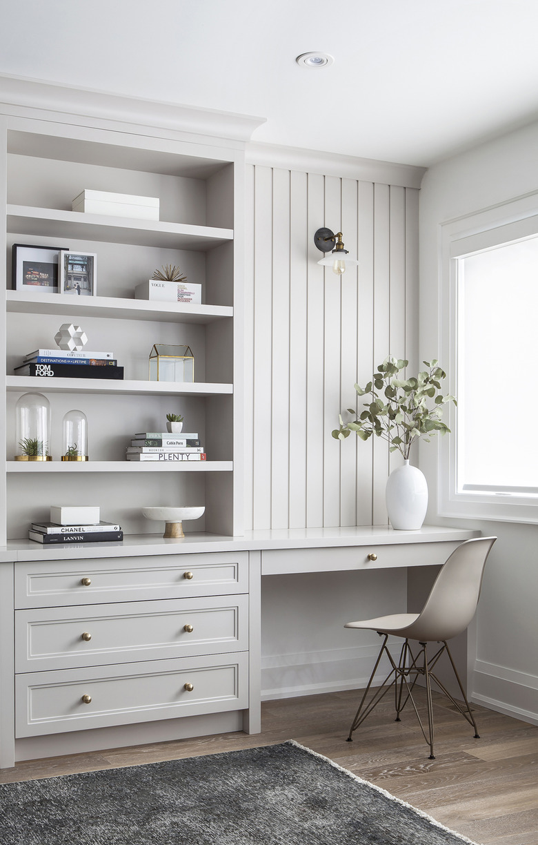 Taupe color office with dary gray rug and built-in desk