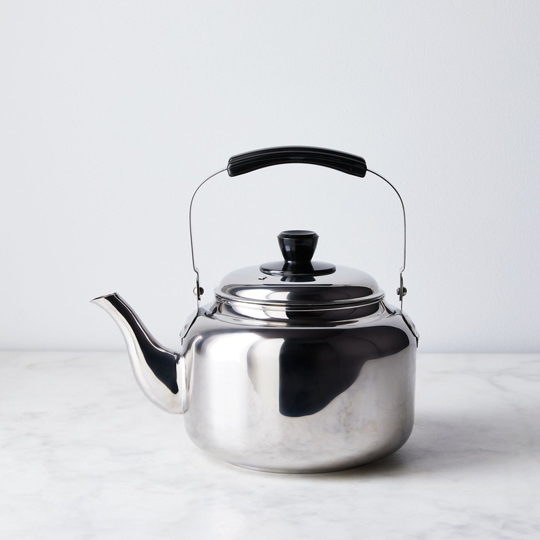 Metal kettle on marble counter