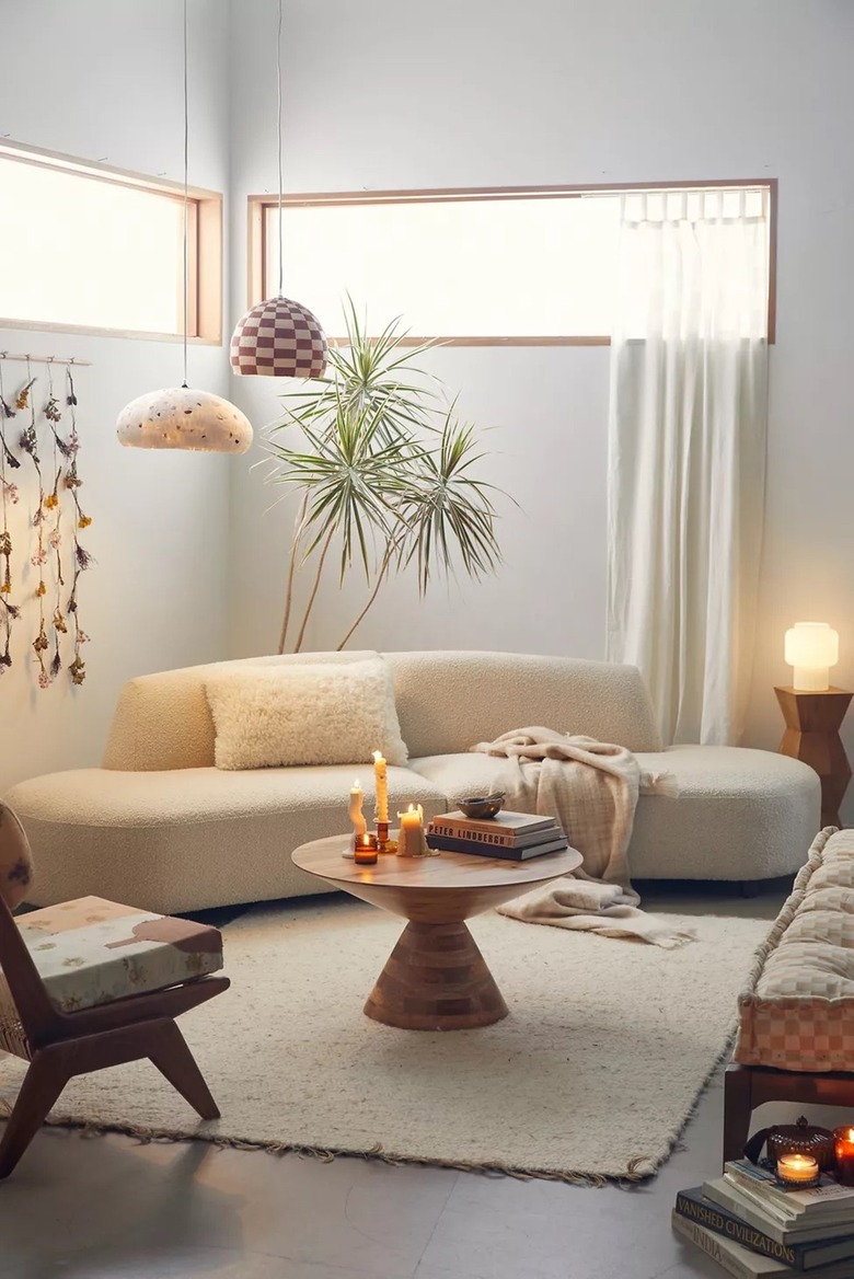 white curved sofa in neutral living room