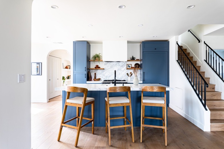 kitchen with blue cabinets and marble backsplash