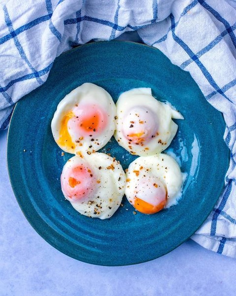 Microwaved poached eggs on a blue plate