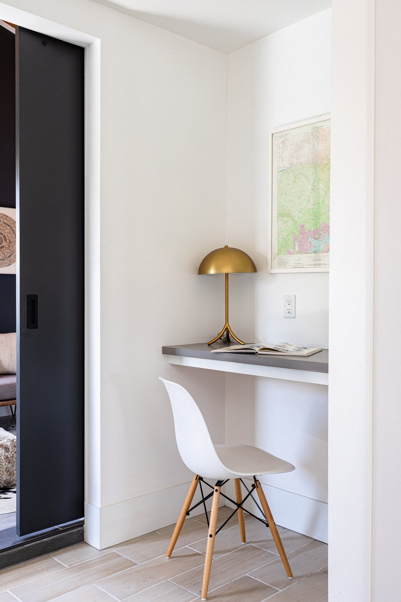 white hallway with desk in the corner