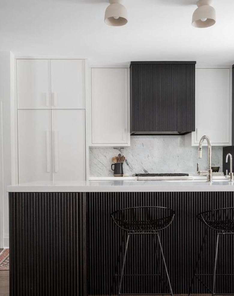 black and white kitchen with reeded details