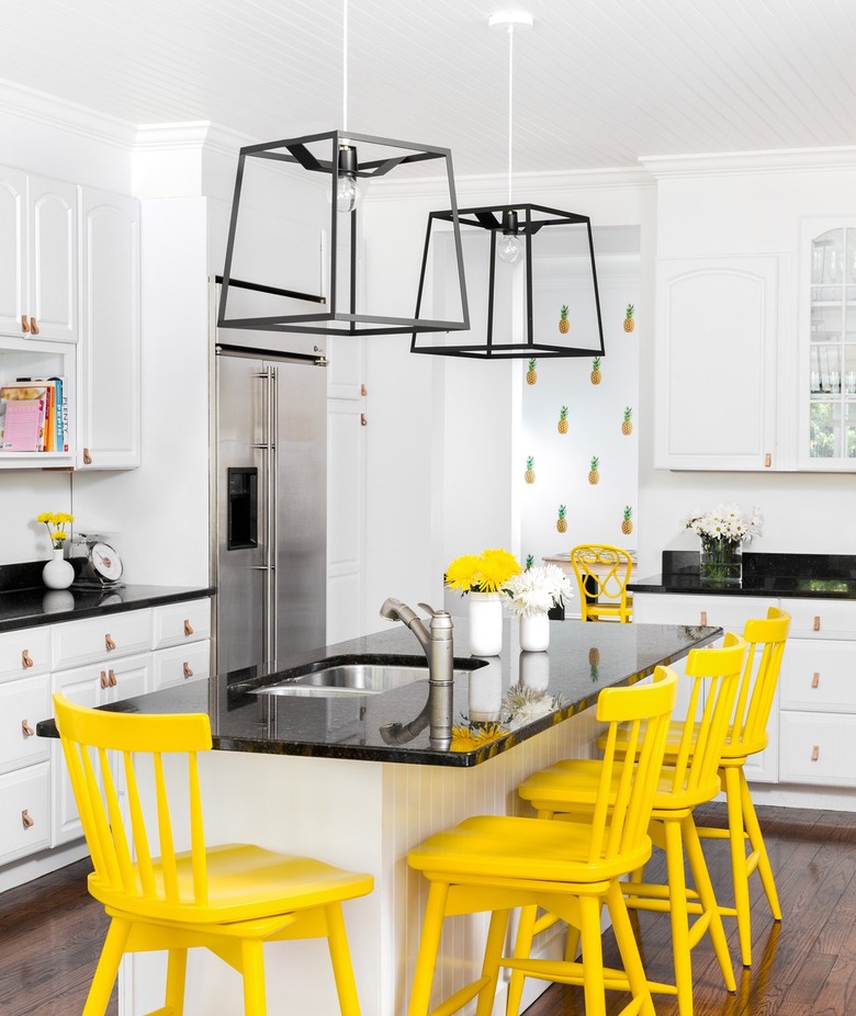 black and white kitchen with yellow accents