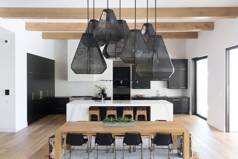 black and white kitchen with black cabinetry and black mesh statement lighting