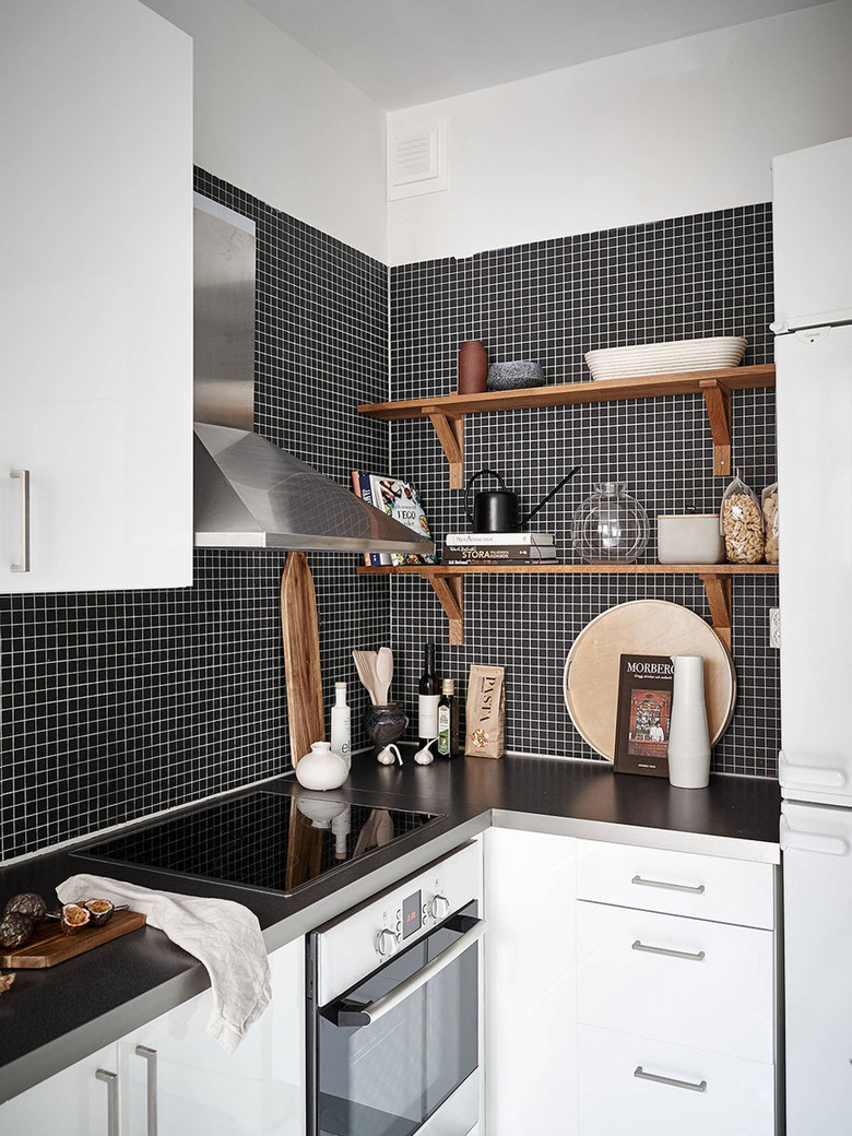 black and white kitchen with black mosaic tiles