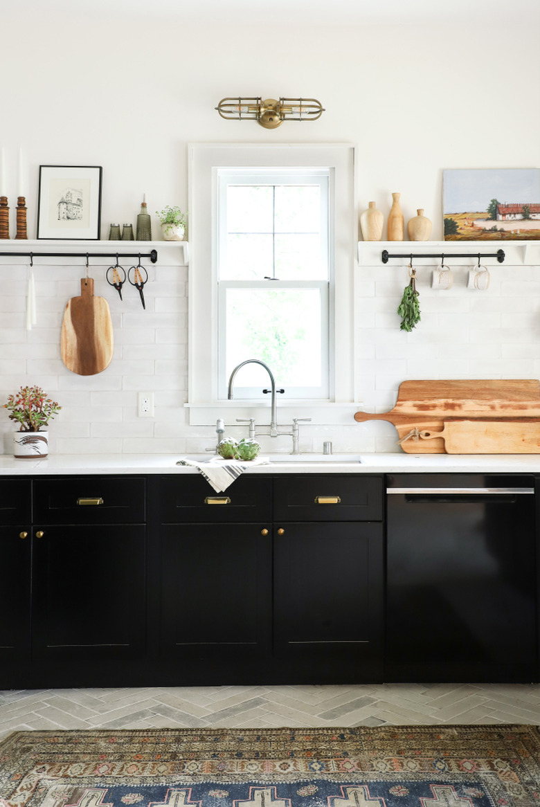 black and white kitchen with brass accents and open shelving