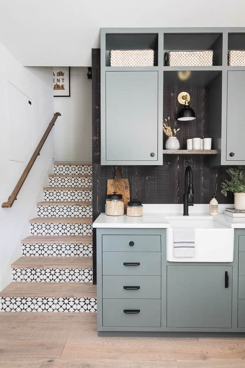 black and white stairs with patterned tile on risers