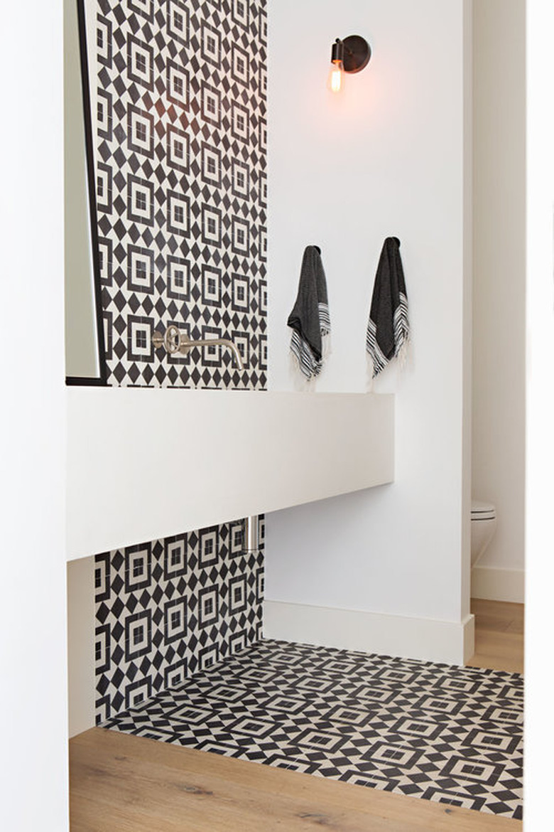 Black bathroom backsplash idea with cement tile, wood floors