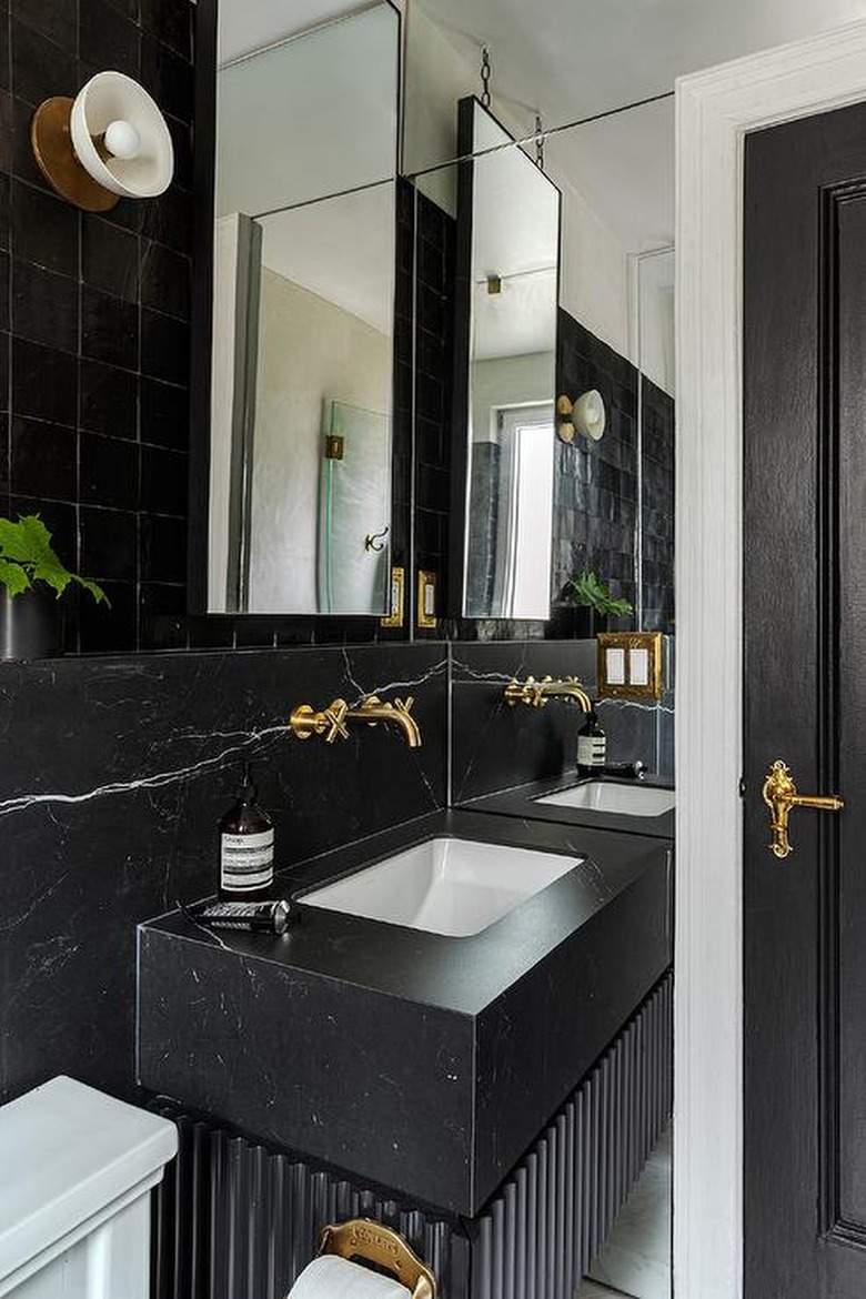 all black bathroom with gold hardware