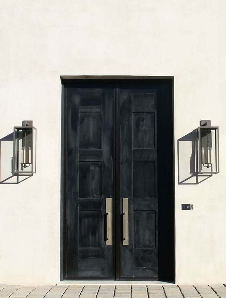 black exterior door idea for white house with industrial lighting