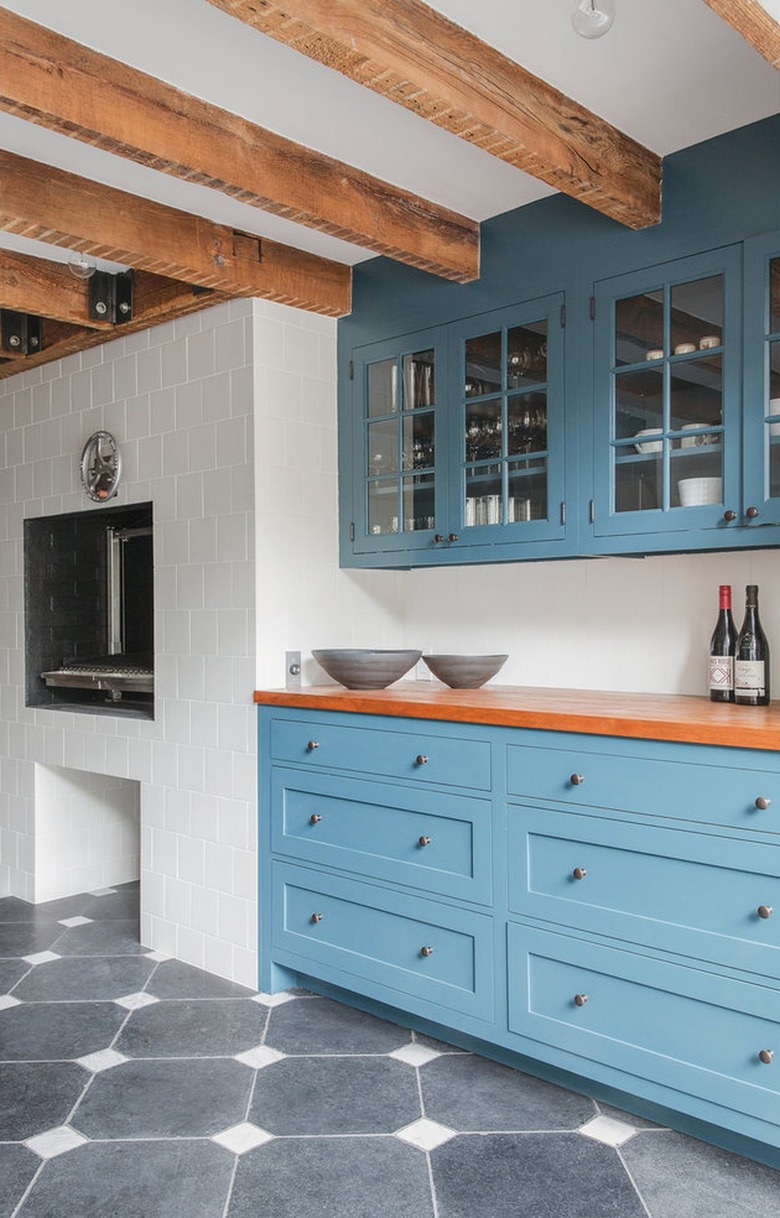 black kitchen floor with blue cabinets