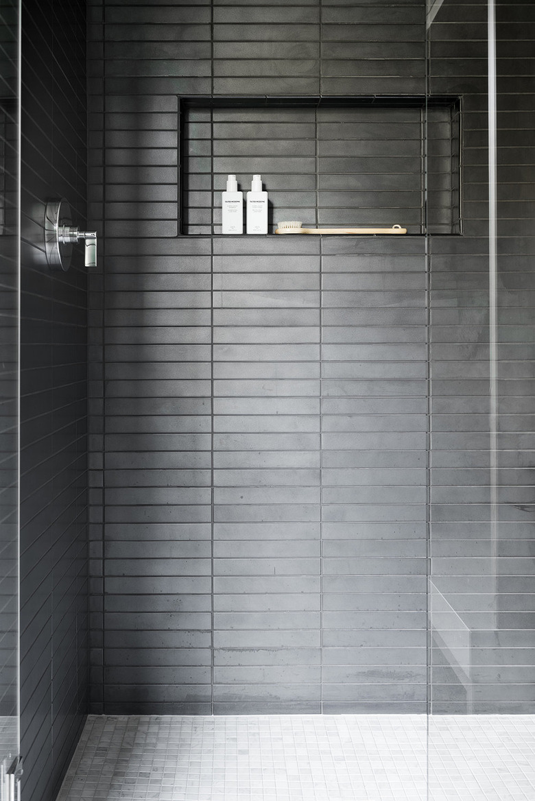 contemporary black tile shower with nook for storage