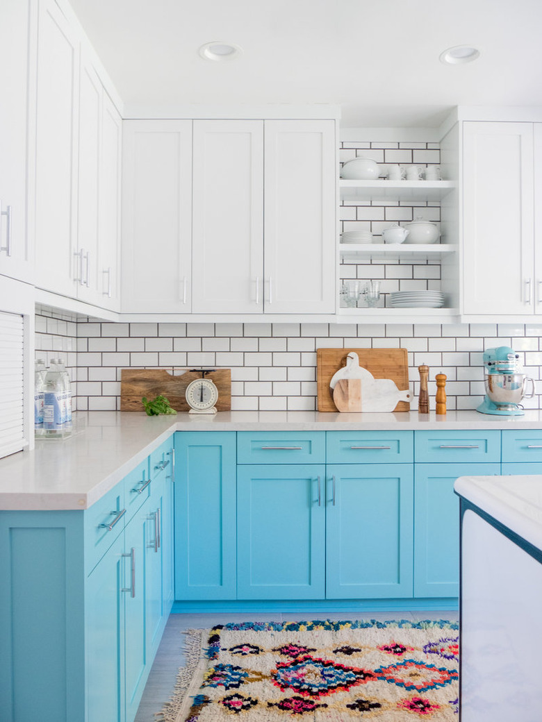 bright blue and white kitchen with white upper cabinets