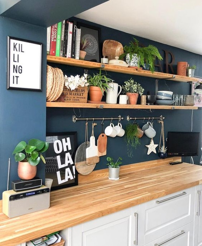 eclectic blue and white kitchen with blue walls and white cabinetry