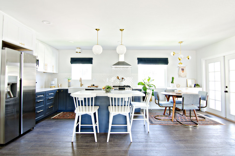 blue and white kitchen that opens to dining room