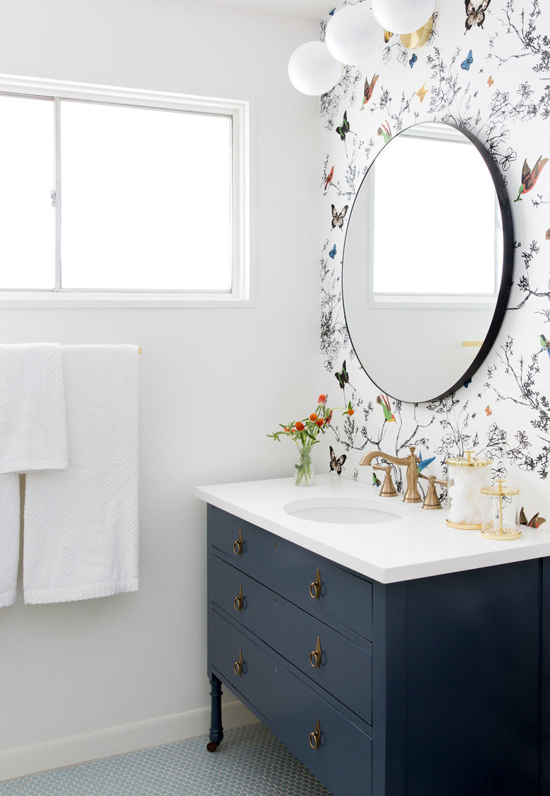 vintage blue bathroom cabinets with floral wallpaper