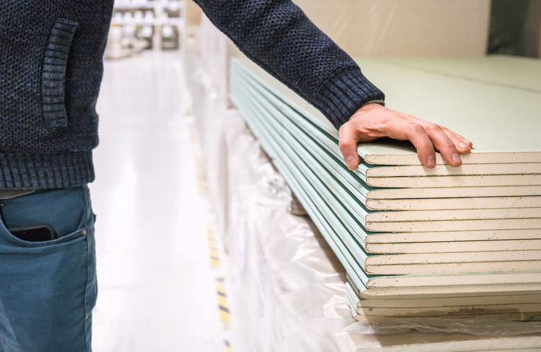 Checking out drywall at a store. Selective focus.