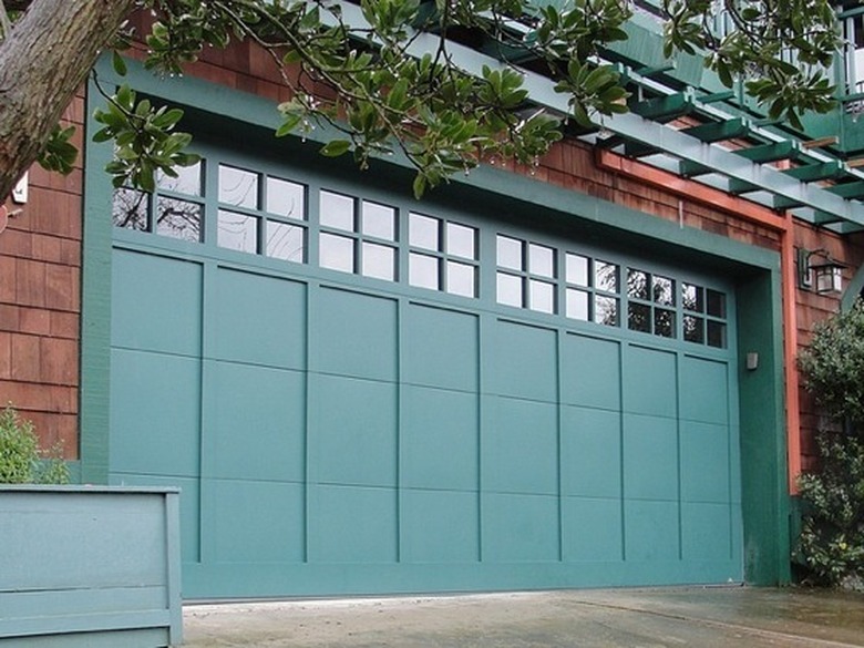 blue-green garage door on wood shingle house