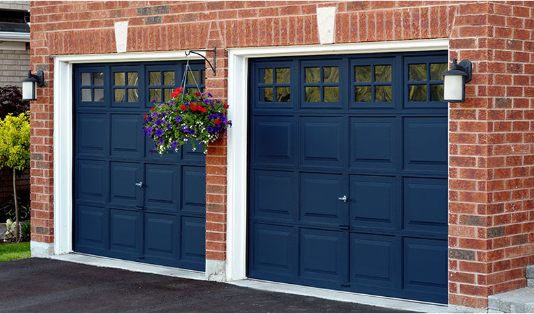 navy blue garage doors on brick house