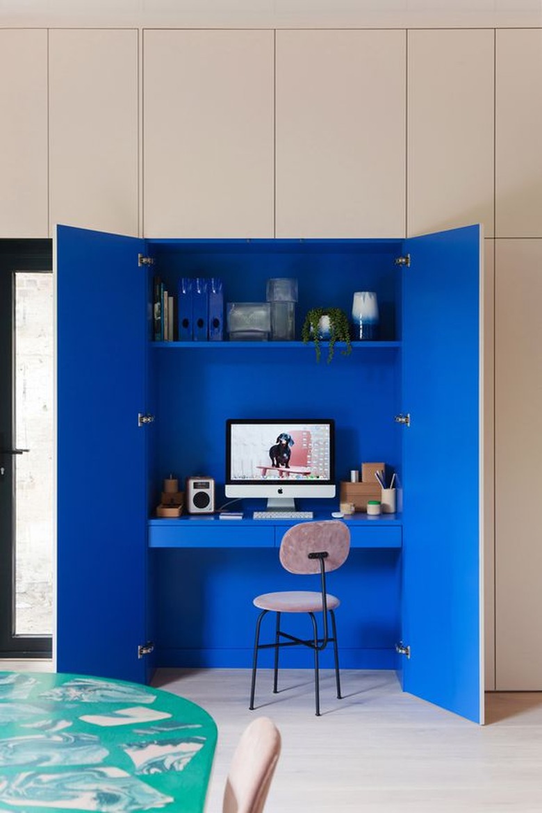 blue home office inside of a closet with a monochrome scheme