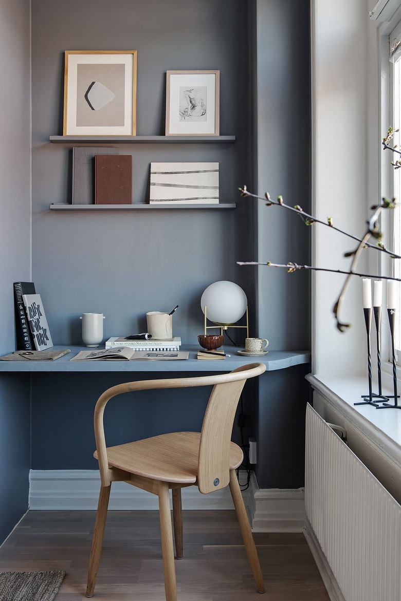 light blue home office in a corner nook with built in shelves