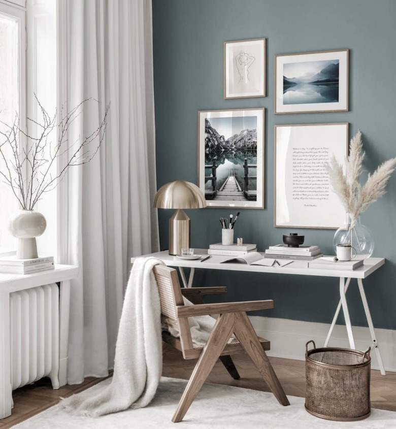 blue home office with an accent wall and white window treatments aside it