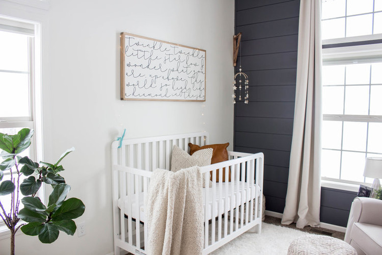 blue nursery idea with shiplap accent wall and drapery at window