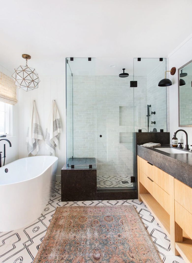 bohemian bathroom idea with glass shower enclosure and patterned floor tile