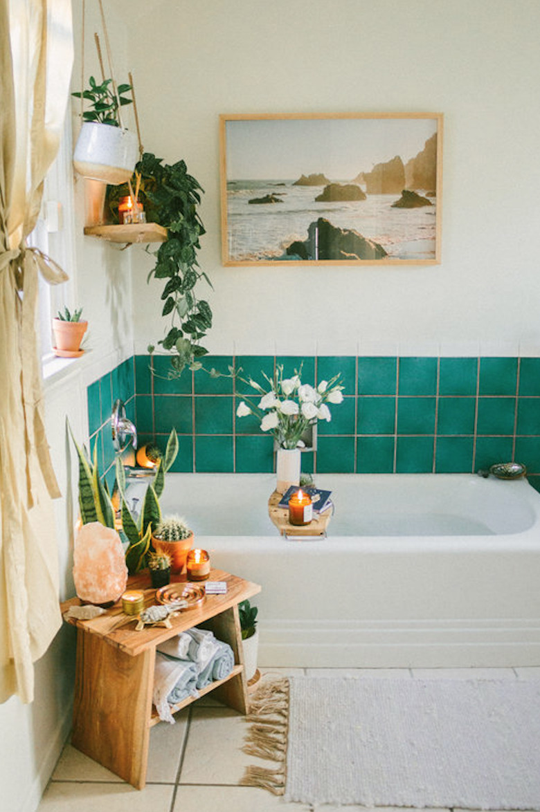 bohemian bathroom idea with green wall tile and potted plants