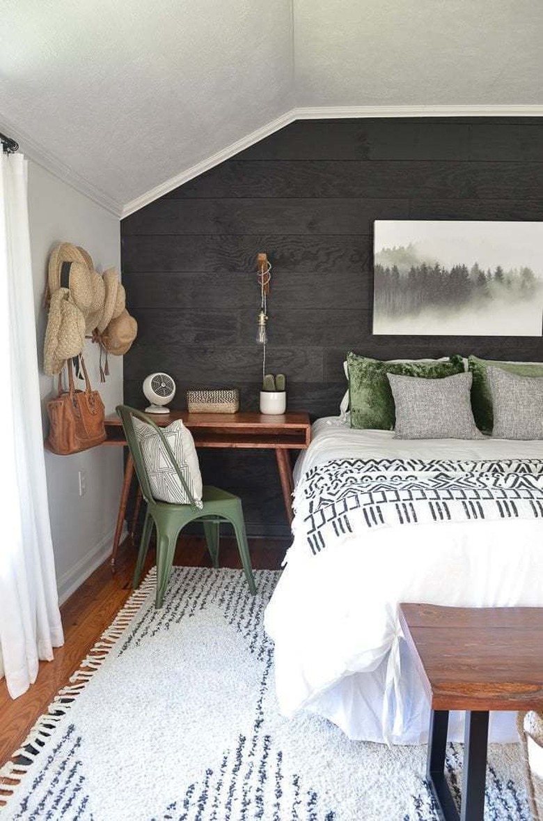 bohemian bedroom idea with thrift store decor and black shiplap wall