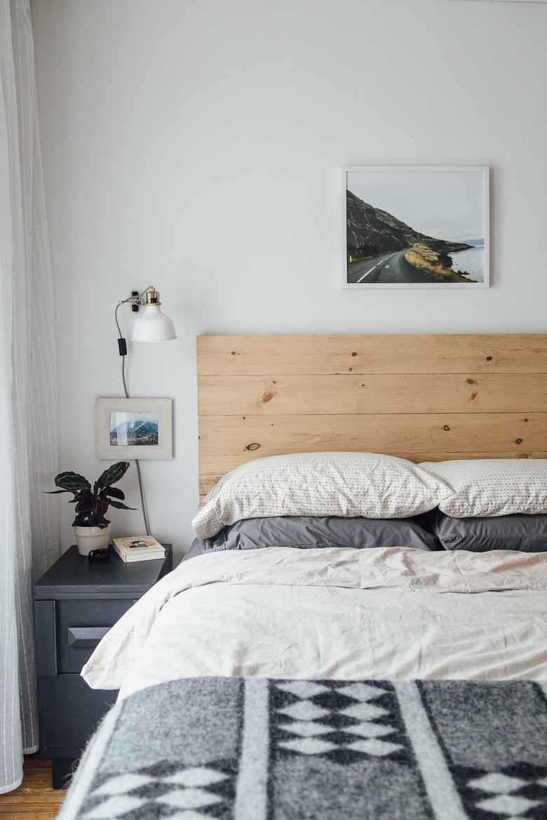 bohemian bedroom idea with DIY headboard, industrial accents, and wall sconces