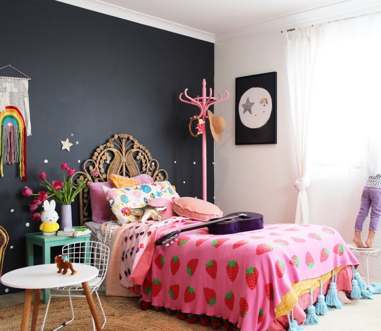 bohemian kids bedroom idea with tasseled blanket and woven headboard