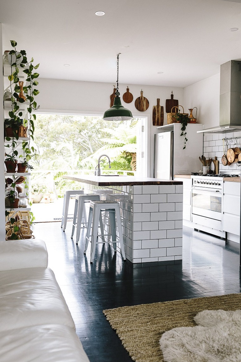 bohemian kitchen with subway tile island and wood countertop