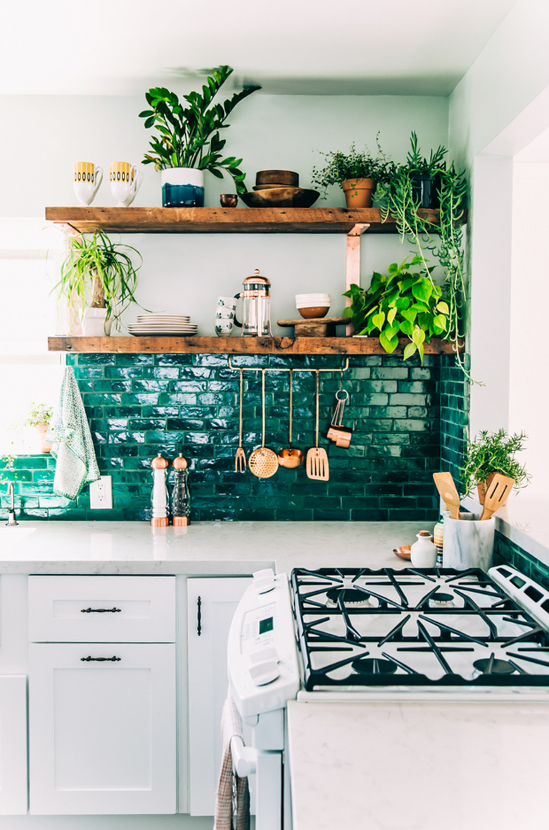 bohemian kitchen with open shelving and green backsplash