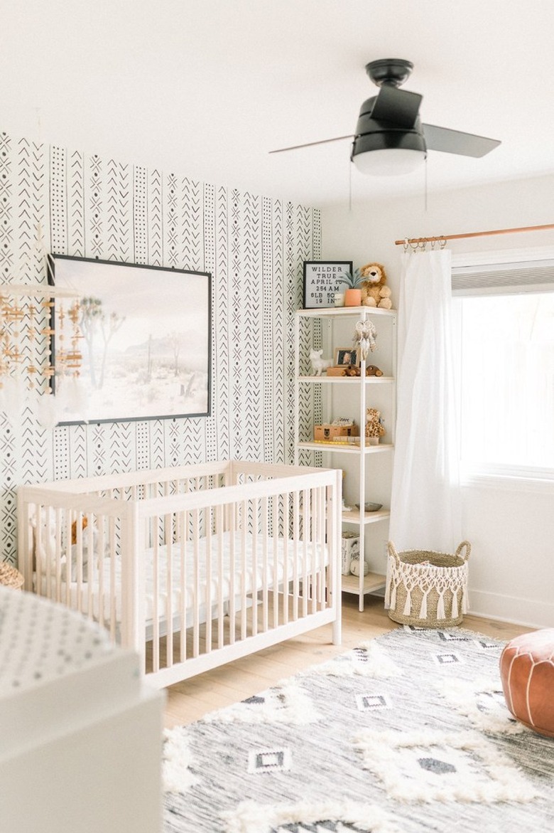 bohemian baby nursery idea with mudcloth-inspired wallpaper and ceiling fan